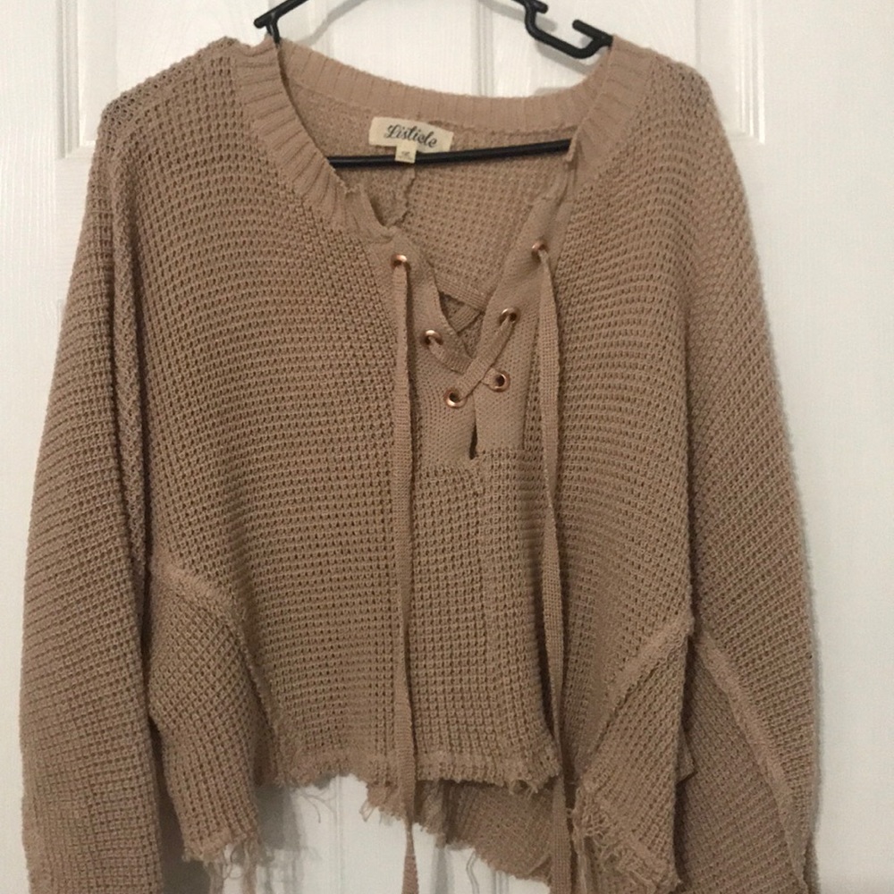 Cropped sweater with raw hem.